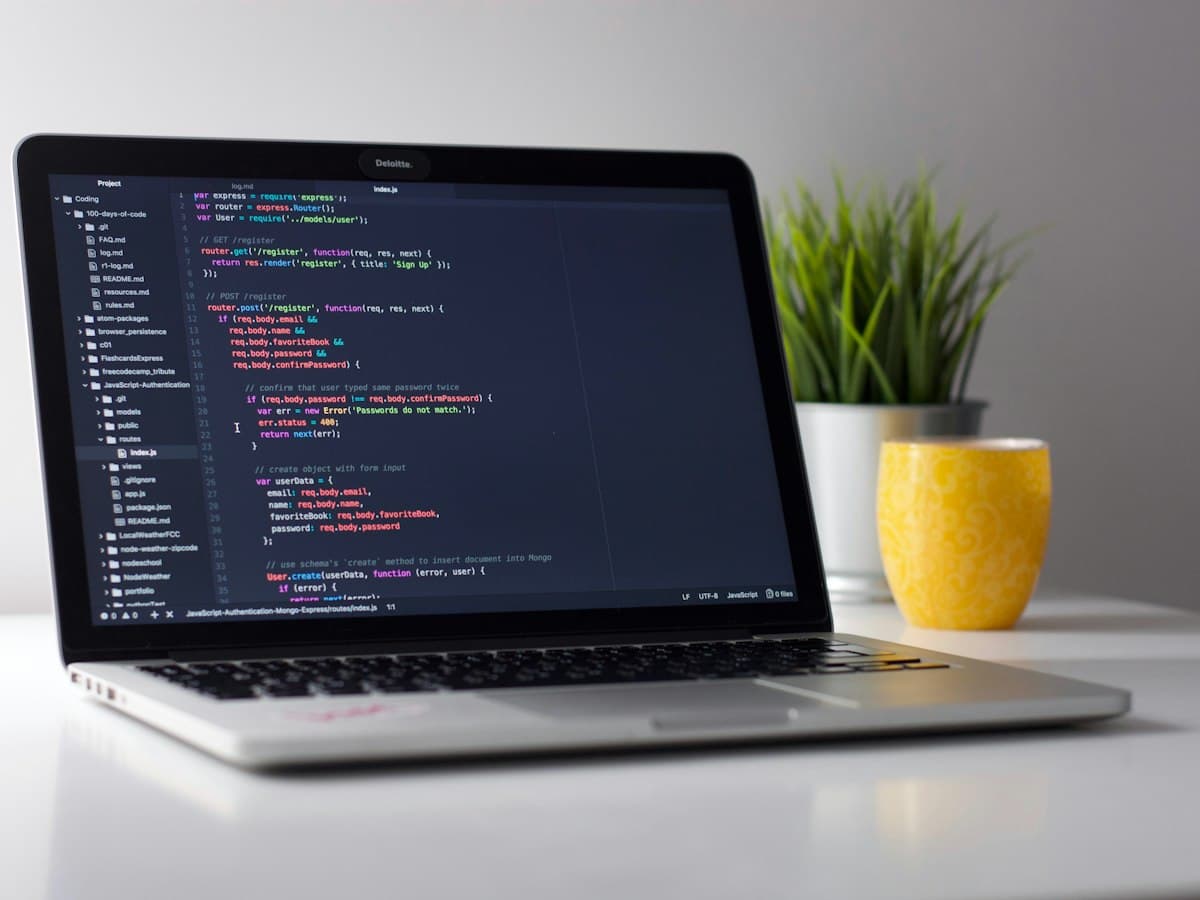 Laptop open to a software development workspace