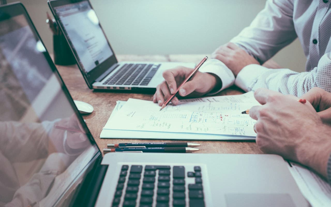 Laptop and proposal documents for a technical project bid